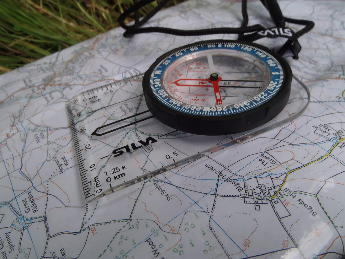 A compass resting on a map, symbolizing direction, choice and reorientation in recovery