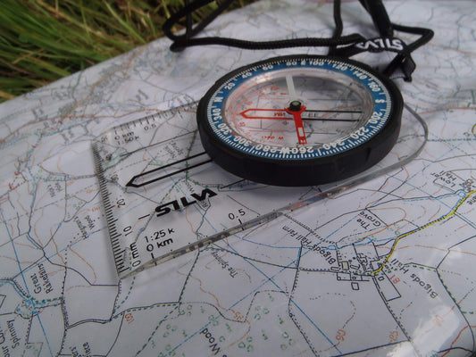 A compass resting on a map, symbolizing direction, choice and reorientation in recovery