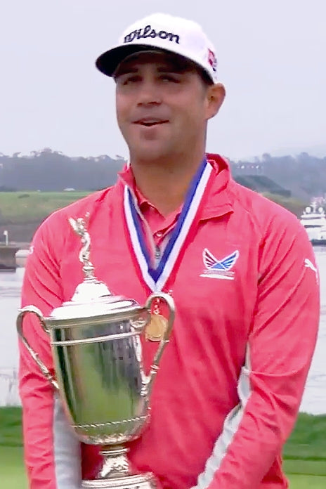 Gary Woodland holding the 2019 U.S. Open trophy in an archival image