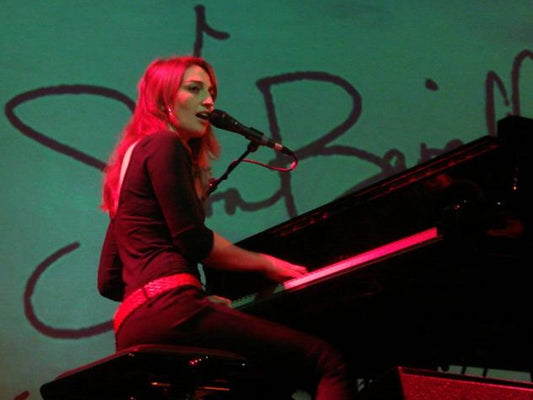 Sara Bareilles performing in Amsterdam in 2008; archival image by Amw9991 via Wikimedia Commons, CC BY-SA