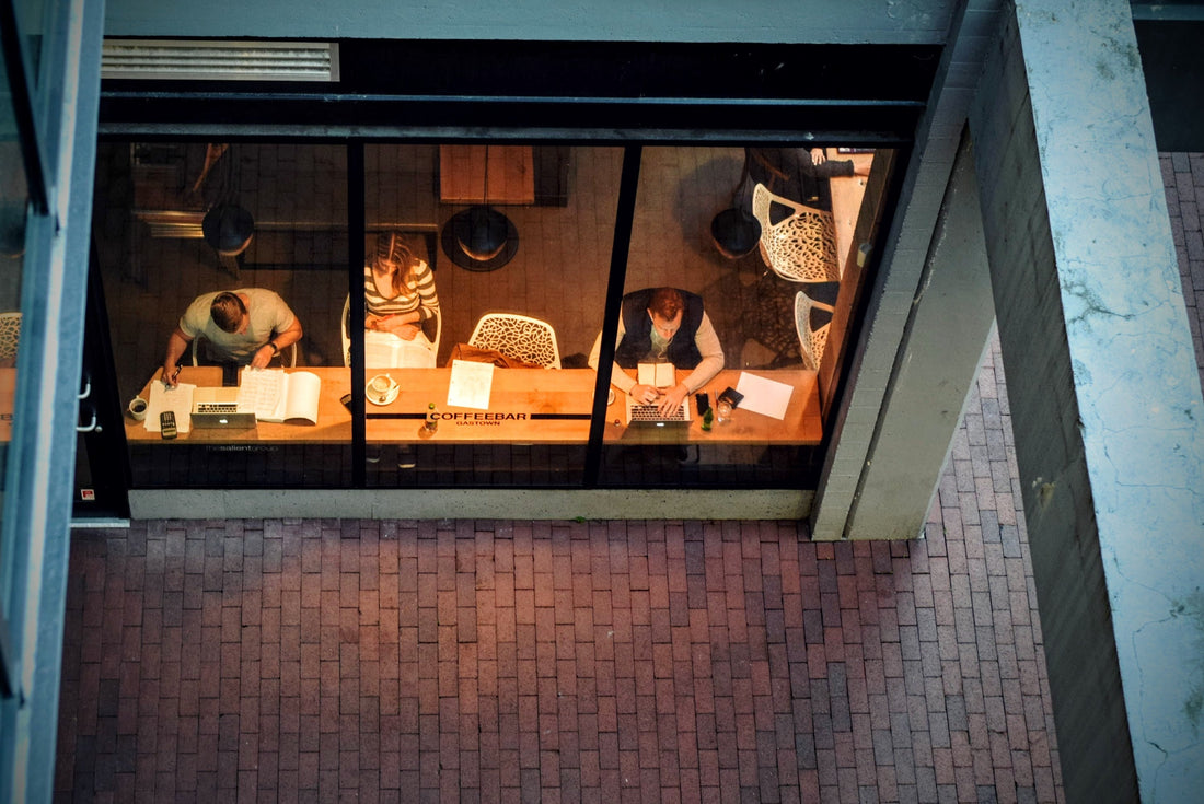 People gathering in a coffee shop, illustrating alcohol-free social connection during Sober October