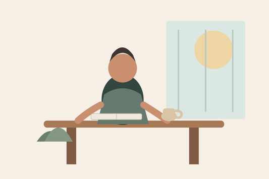 A wide quiet reflection scene with a journal and warm drink before a one-year sobriety milestone.