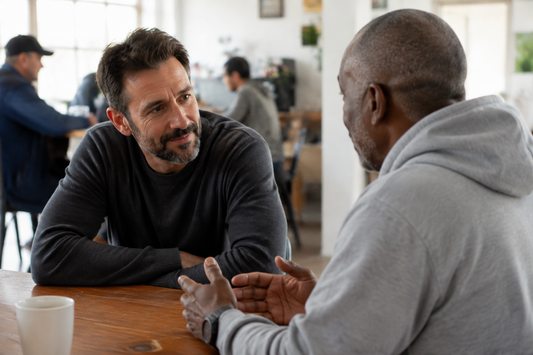 Two adults sharing a respectful supportive conversation during Recovery Month.