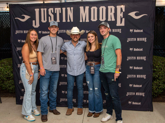 Justin Moore backstage with U.S. Air Force members at the 2023 Hometown Heroes concert in Ohio. U.S. Air Force photo by Matthew Fink, public domain. Archival image, not from the August 2026 sobriety interview.