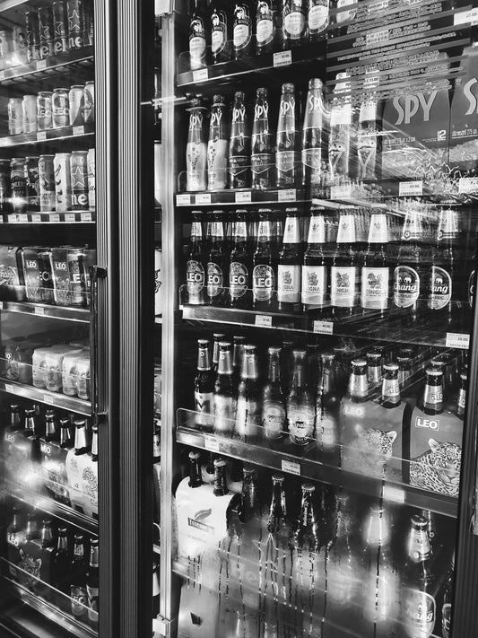 Beer bottles and cans displayed on retail shelves, illustrating how similar beverage packaging can create selection mistakes; this image does not depict BrewDog products.