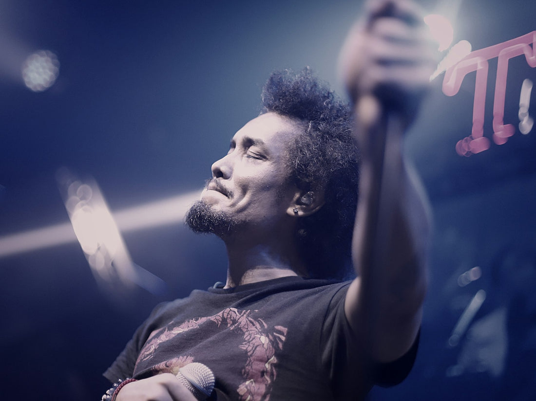 Illustrative image of a male singer performing on stage with a microphone