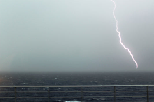 A wide thunderstorm over the sea with lightning, used as a universal storm symbol rather than Marvel artwork.