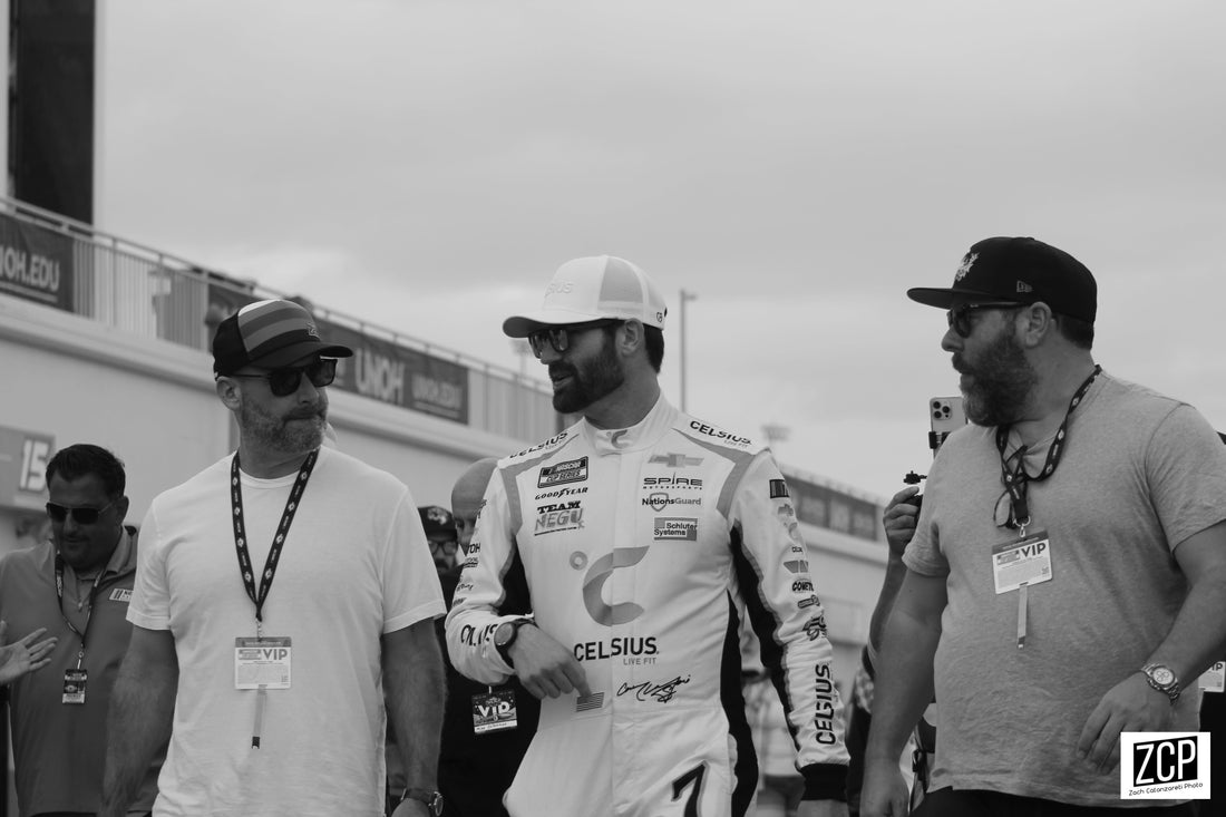 Tom Segura with Corey LaJoie and Bert Kreischer at the 2023 Daytona 500; archival public-event image.
